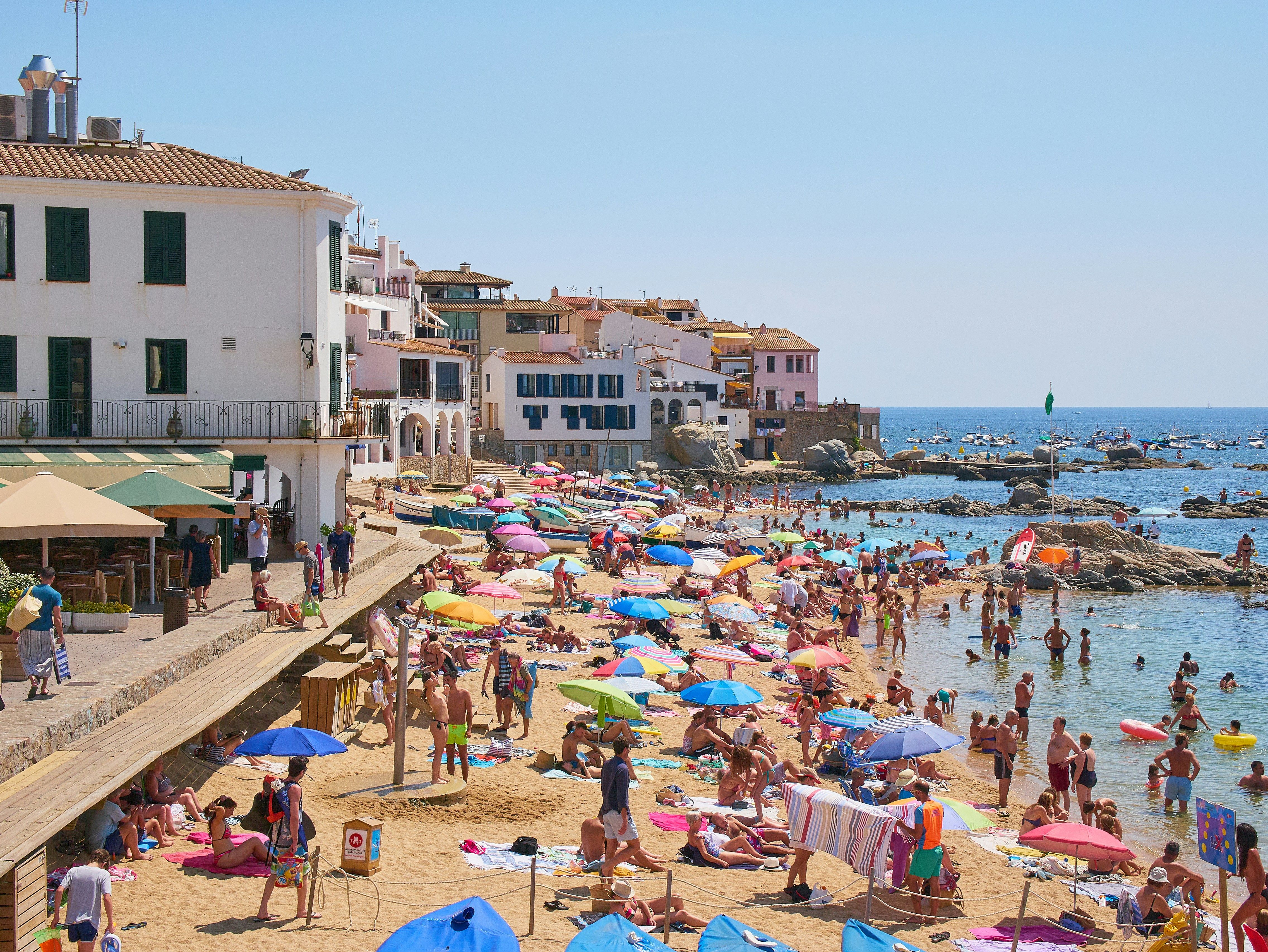 full beach of tourists at the costa blanca in spain